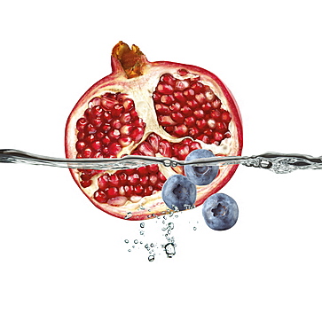 Half A Pomegranate And Blueberries Floating In Water