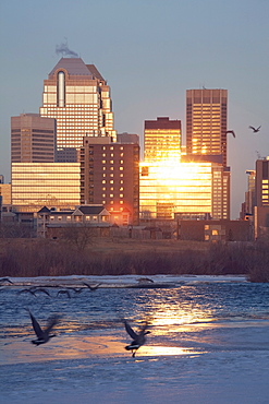 Calgary, Alberta, Canada; Bow River And Buildings Reflecting The Sun In Winter