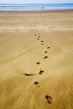 Devon, England; Footprints In The Sand At Woolacombe