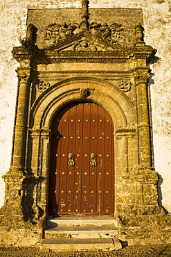 Medina Sidonia, Andalusia, Spain; The Wooden Door To The Iglesia Mayor With An Ornate Stone Frame