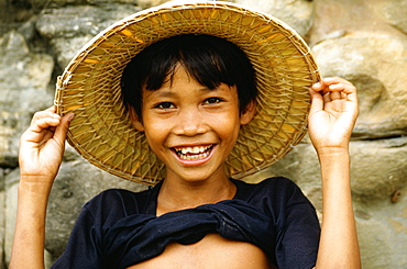 Portrait of a boy smiling and holding a straw hat, Angkor Thom, Angkor, Siem Reap, Cambodia