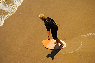 High angle view of a boogie boarder on the beach