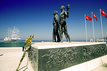 Statues at a monument with flags of Turkey, Monument of Ataturk and Youth, Kusadasi, Turkey