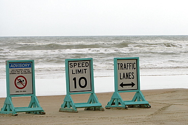 Close-up of signboards on the beach