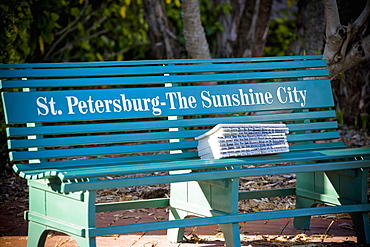 Stack of books on a park bench, St. Petersburg, Florida, USA