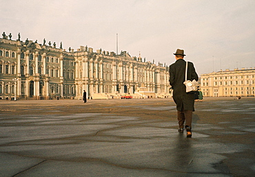 Rear view of a man walking in front of a palace, Winter Palace, Hermitage Museum, St. Petersburg, Russia