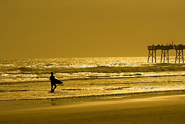 Silhouette of a person walking on the beach, Daytona Beach, Florida, USA