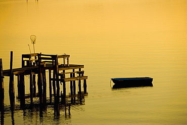 Boat near a pier with a fishing net, St. Augustine Beach, Florida, USA