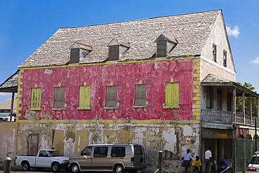 Two vehicles parked beside a house, Bay Street, Nassau, Bahamas