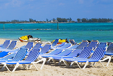 Beach chairs and jet boats on the beach, Cable Beach, Nassau, Bahamas