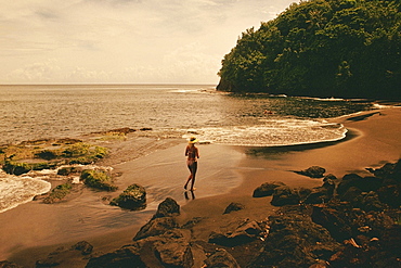 High angle view of a woman running on the beach, Tahiti, Society Islands, French Polynesia