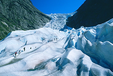 Hikers climbing a mountain, Briksdalsbreen Glacier, Norway