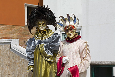 Close-up of two people wearing masquerade masks, Venice, Italy