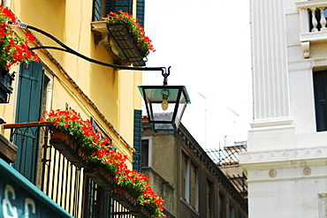 Low angle view of a lantern and window boxes, Venice, Italy