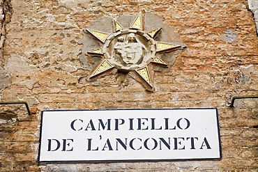 Close-up of a nameplate on a brick wall, Venice, Italy