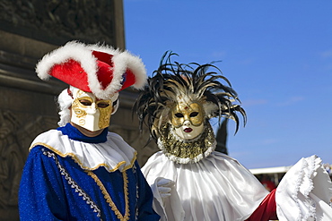 Close-up of two people wearing masquerade masks, Venice, Italy