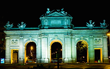 Memorial gate lit up at night, Alcala Gate, Madrid, Spain