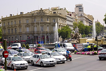 Traffic on a road in front of a palace, Cibeles Fountain, Palacio de Linares, Plaza de Cibeles, Madrid, Spain