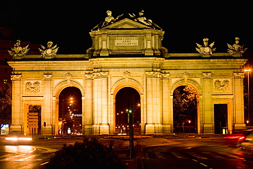 Memorial gate lit up at night, Alcala Gate, Madrid, Spain