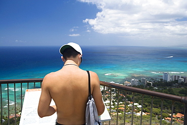 Rear view of a man standing at an observation point, Diamond Head, Waikiki Beach, Honolulu, Oahu, Hawaii Islands, USA