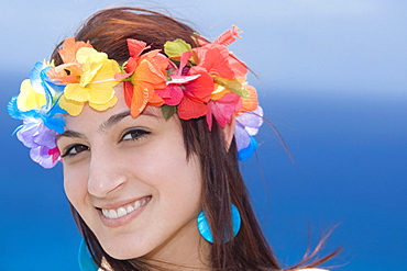 Portrait of a young woman wearing lei and smiling, Diamond Head, Waikiki Beach, Honolulu, Oahu, Hawaii Islands, USA