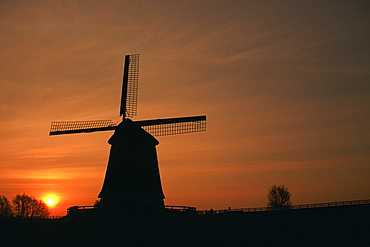 Silhouette of a traditional windmill at dusk, Schermer, Netherlands