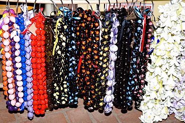 Close-up of garlands and necklaces hanging in a store