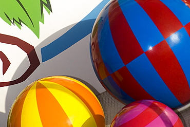 Close-up of a knob and balls on a multi-colored wall