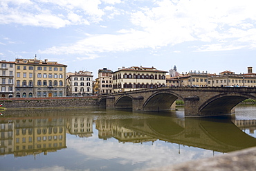 Reflection of an arch bridge in water, Ponte Santa Trinita Bridge, Arno River, Florence, Italy