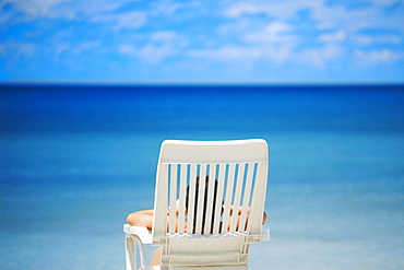 Rear view of a person lying on a lounge chair on the beach, South West Bay, Providencia, Providencia y Santa Catalina, San Andres y Providencia Department, Colombia