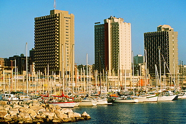 Boats docked at a harbor in front of buildings, Tel Aviv, Israel