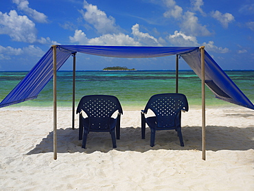 Empty chairs under the tent on the beach, Spratt Bight Beach, San Andres, Providencia y Santa Catalina, San Andres y Providencia Department, Colombia