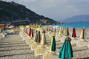 Lounge chairs and beach umbrellas on the beach, Rhodes, Dodecanese Islands, Greece