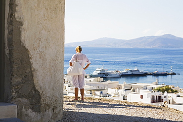 Rear view of a woman looking at a view, Mykonos, Cyclades Islands, Greece