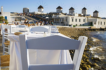 Tables and chairs in a restaurant at the coast, Mykonos, Cyclades Islands, Greece