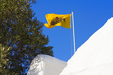 Low angle view of a flag over a monastery, Monastery of the Apocalypse, Patmos, Dodecanese Islands, Greece