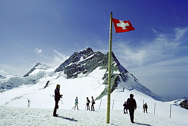 Group of people standing near the Swiss Flag, Jungfrau, Switzerland