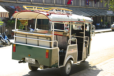 Rear view of a man driving a jinrikisha, Vientiane, Laos