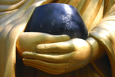 Close-up of a statue holding a bowl, Vientiane, Laos