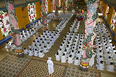 High angle view of a group of people praying in a monastery, Cao Dai Monastery, Tay Ninh, Vietnam