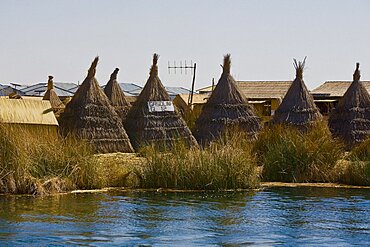 Huts in a village at the waterfront, Lake Titicaca, Uros Floating Islands, Puno, Peru