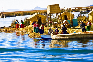 Group of people at a lakeside, Lake Titicaca, Uros Floating Islands, Puno, Peru