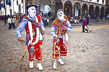 Two people wearing traditional costumes in a festival, Peru