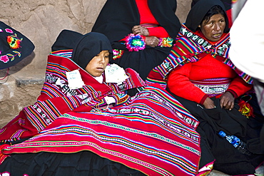 Mature woman sitting with a young woman at a wedding ceremony, Taquile Island, Lake Titicaca, Puno, Peru