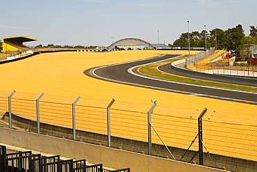 Chain-link fence along with a motor racing tracks in a field, Le Mans, France