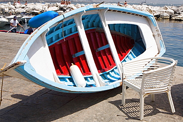 Boat with a chair at the coast, Bay of Naples, Naples, Naples Province, Campania, Italy