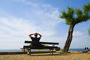 Couple resting on a bench, St. Martin, Biarritz, France