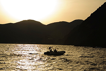 Silhouette of two people in an inflatable raft, Italian Riviera, Mar Ligure, Genoa, Liguria, Italy