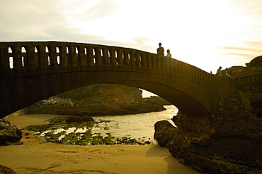 Tourists on the bridge over a beach, Port Des Pecheurs, Biarritz, France