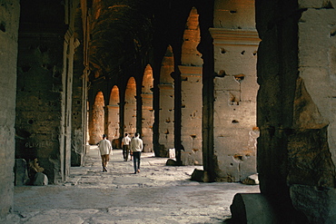 Tourists walking inside a coliseum, Rome, Italy